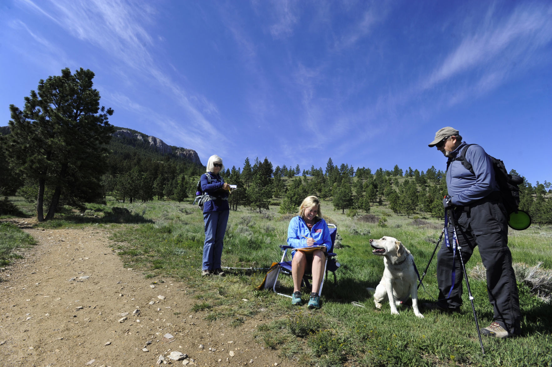 Karen Reese, center, conducts a trail survey